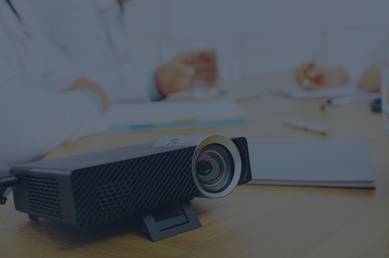 lab1 Projector on a table with doctors in the background